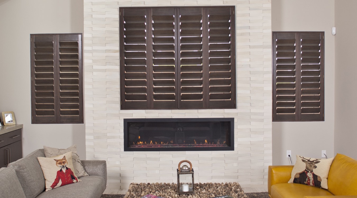 Ovation shutters in a living room with a fireplace